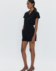 Woman wearing a black outfit on a white background
