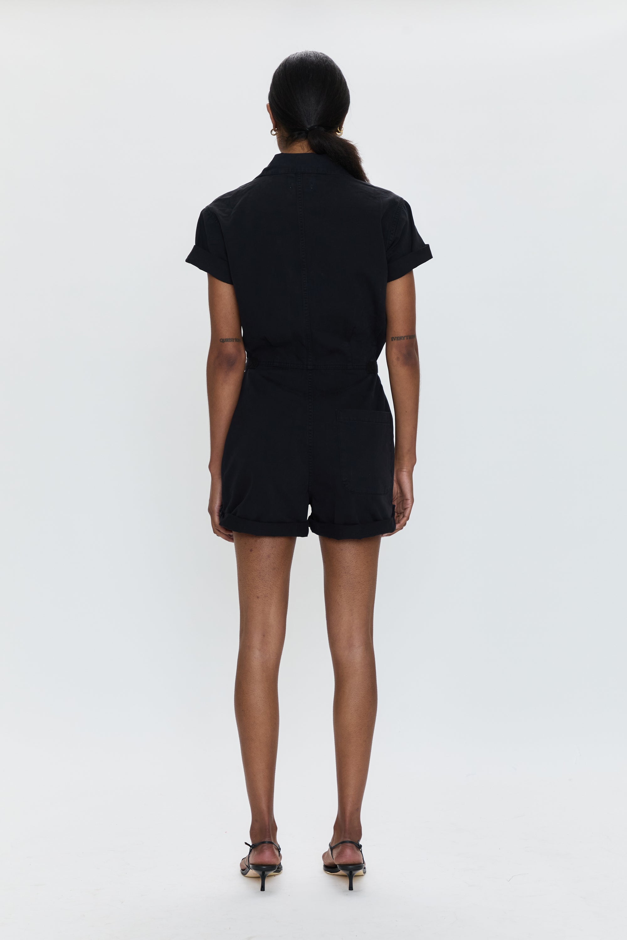 Person wearing a black outfit on a white background