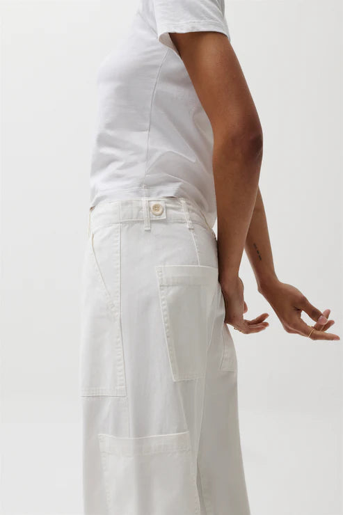 Person wearing a white outfit on a plain background