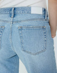 Light blue jeans with a white background