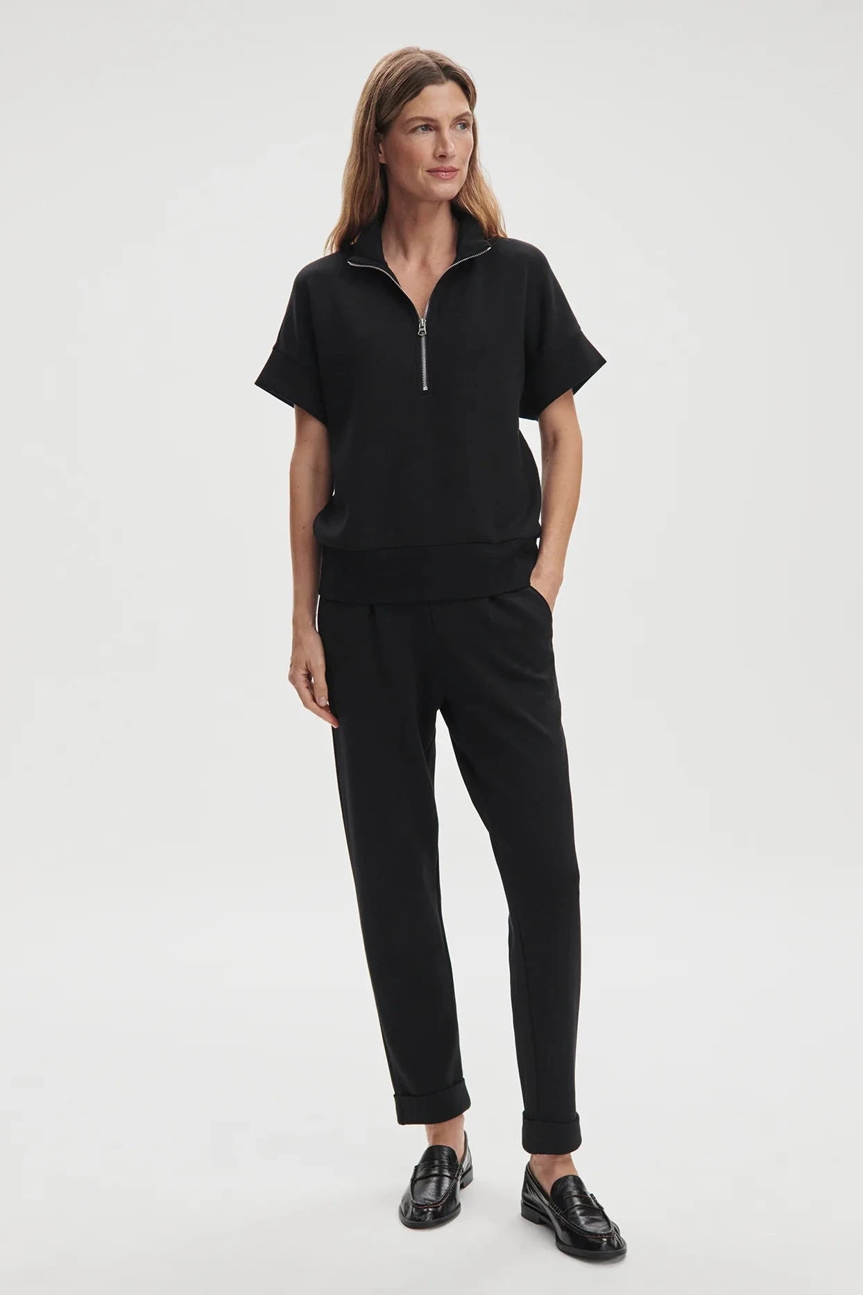 Woman wearing a black outfit on a white background