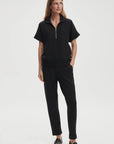 Woman wearing a black outfit on a white background