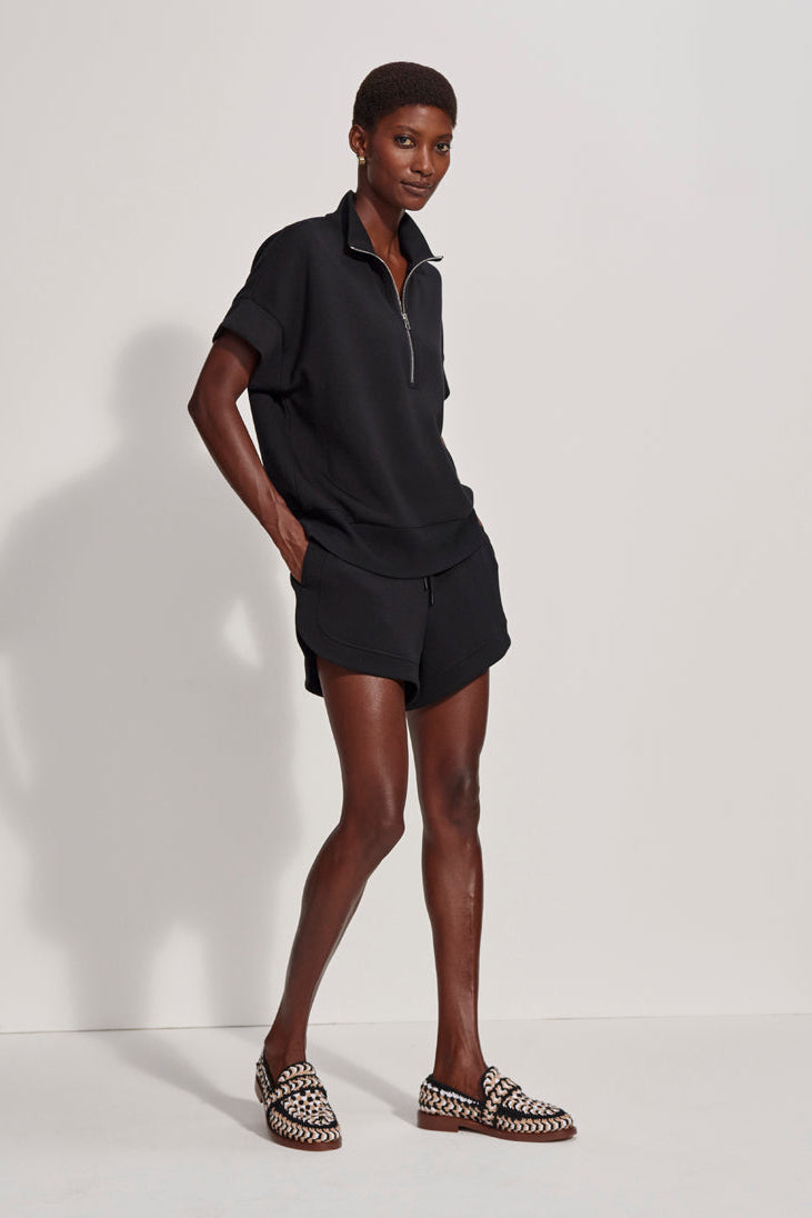 Person wearing a black outfit with a white background