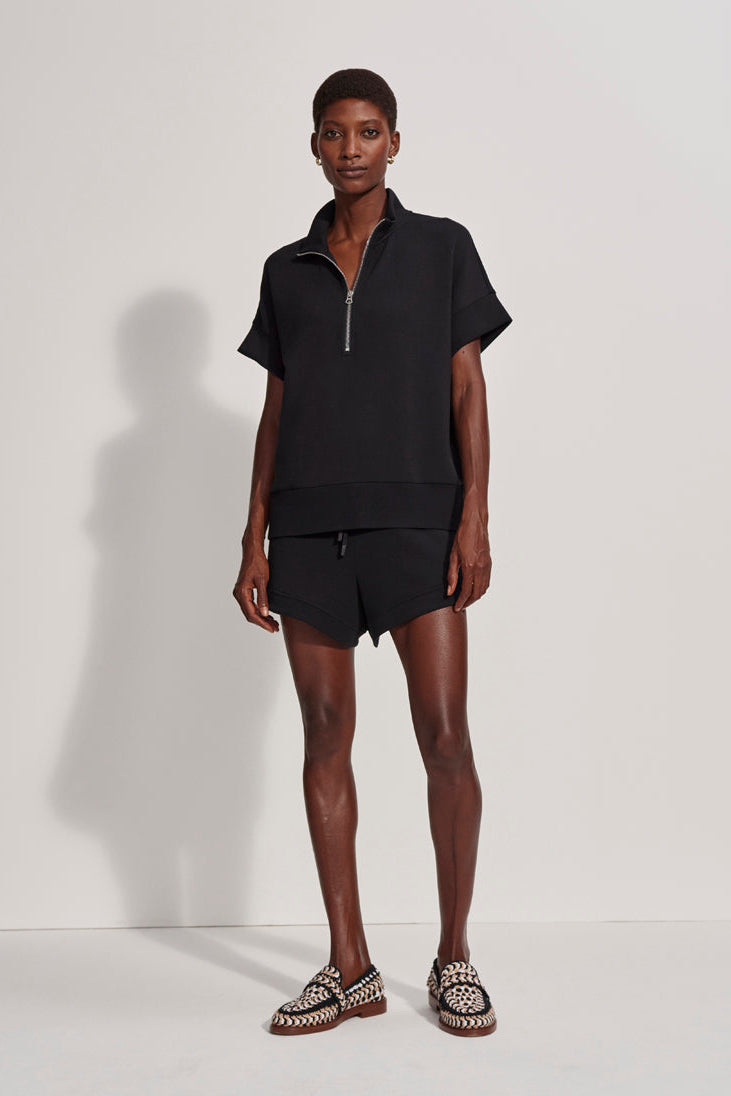 Person wearing a black outfit with a white background