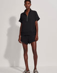 Person wearing a black outfit with a white background