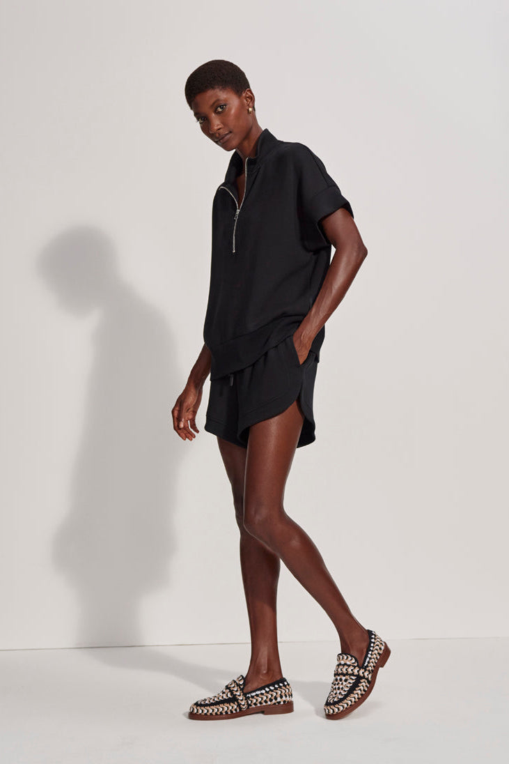 Woman wearing a black dress with a white background