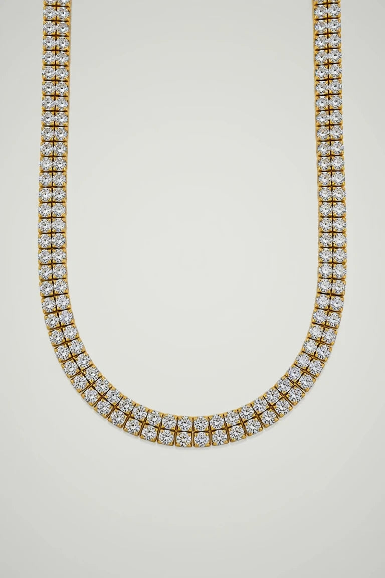 Gold necklace with diamonds on a white background