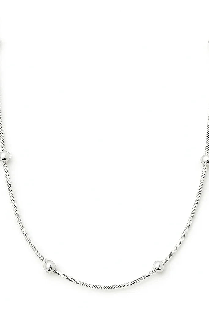 Silver necklace with small beads on a white background