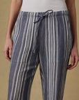 Striped pants worn by a person on a beige background