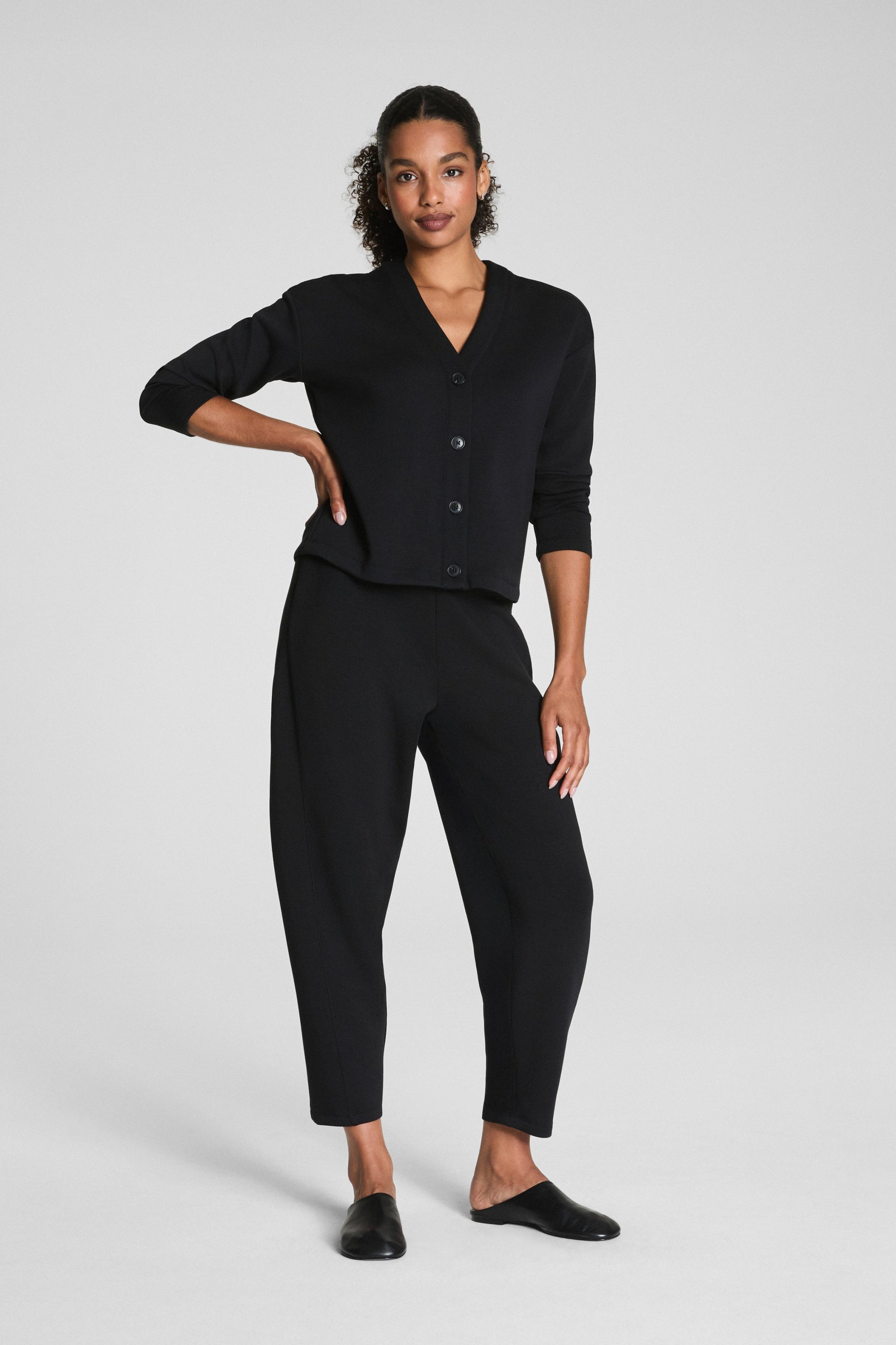 Woman wearing a black outfit on a white background