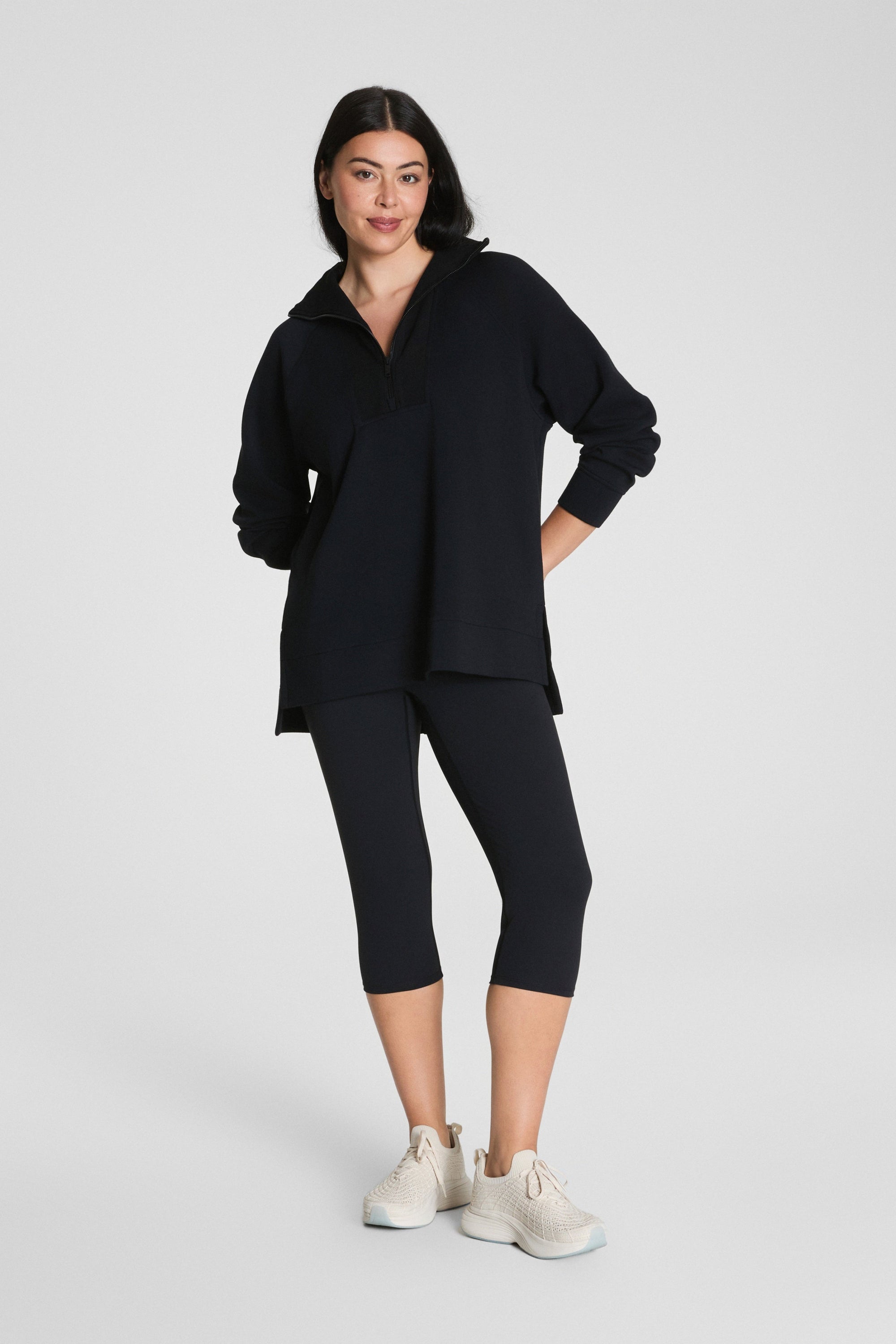 Woman wearing a black outfit on a white background