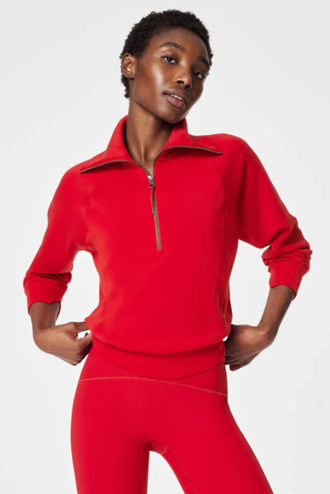 Person wearing a red fleece outfit on a white background