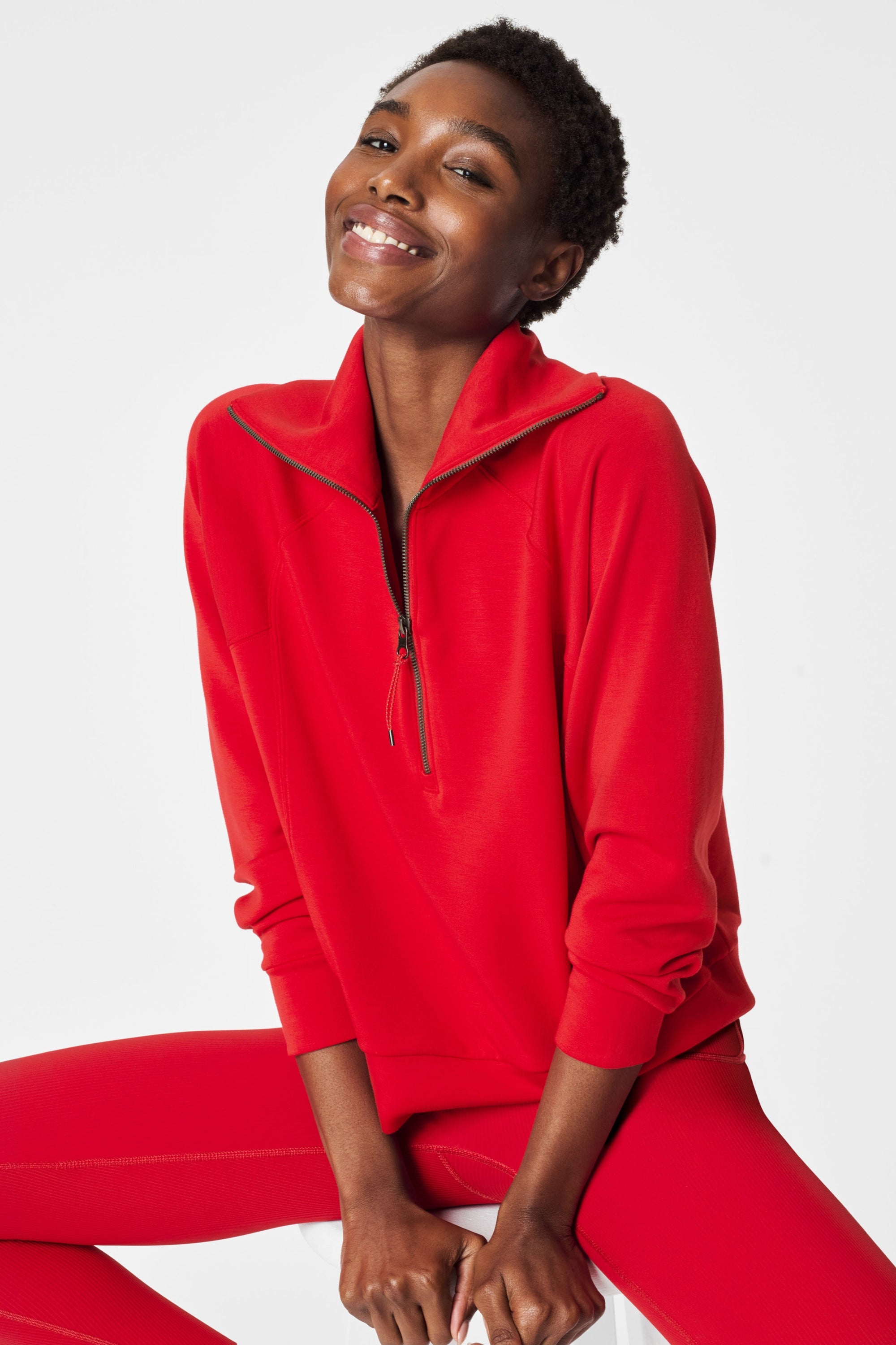 Person wearing a red tracksuit on a white background