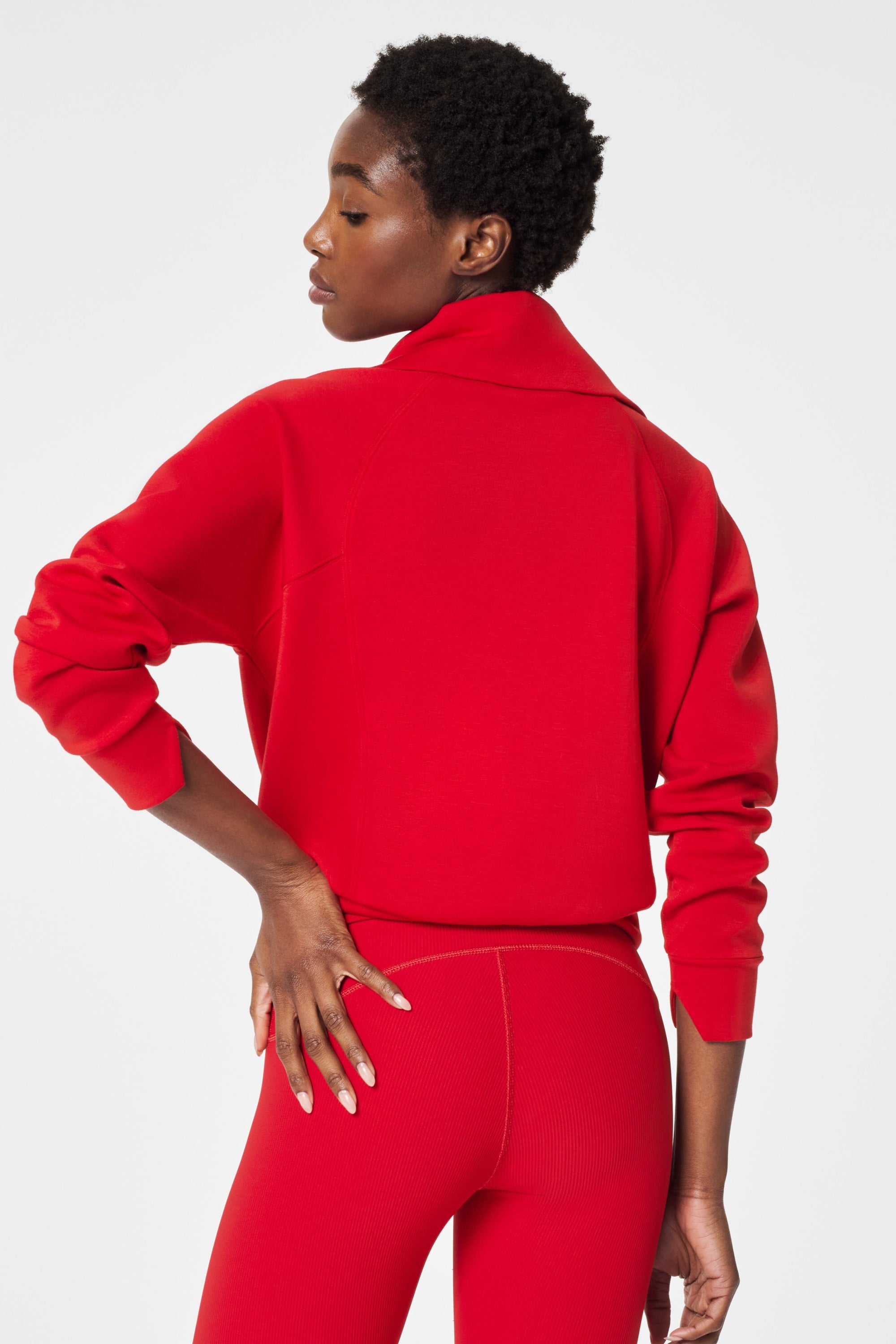 Person wearing a red tracksuit on a white background