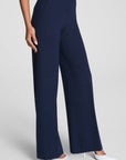 Navy blue wide-leg pants worn by a person on a light gray background