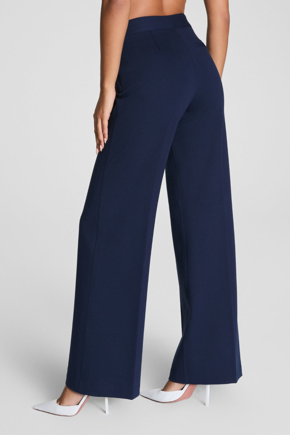 Navy blue wide-leg pants worn by a person on a light gray background