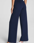 Navy blue wide-leg pants worn by a person on a light gray background