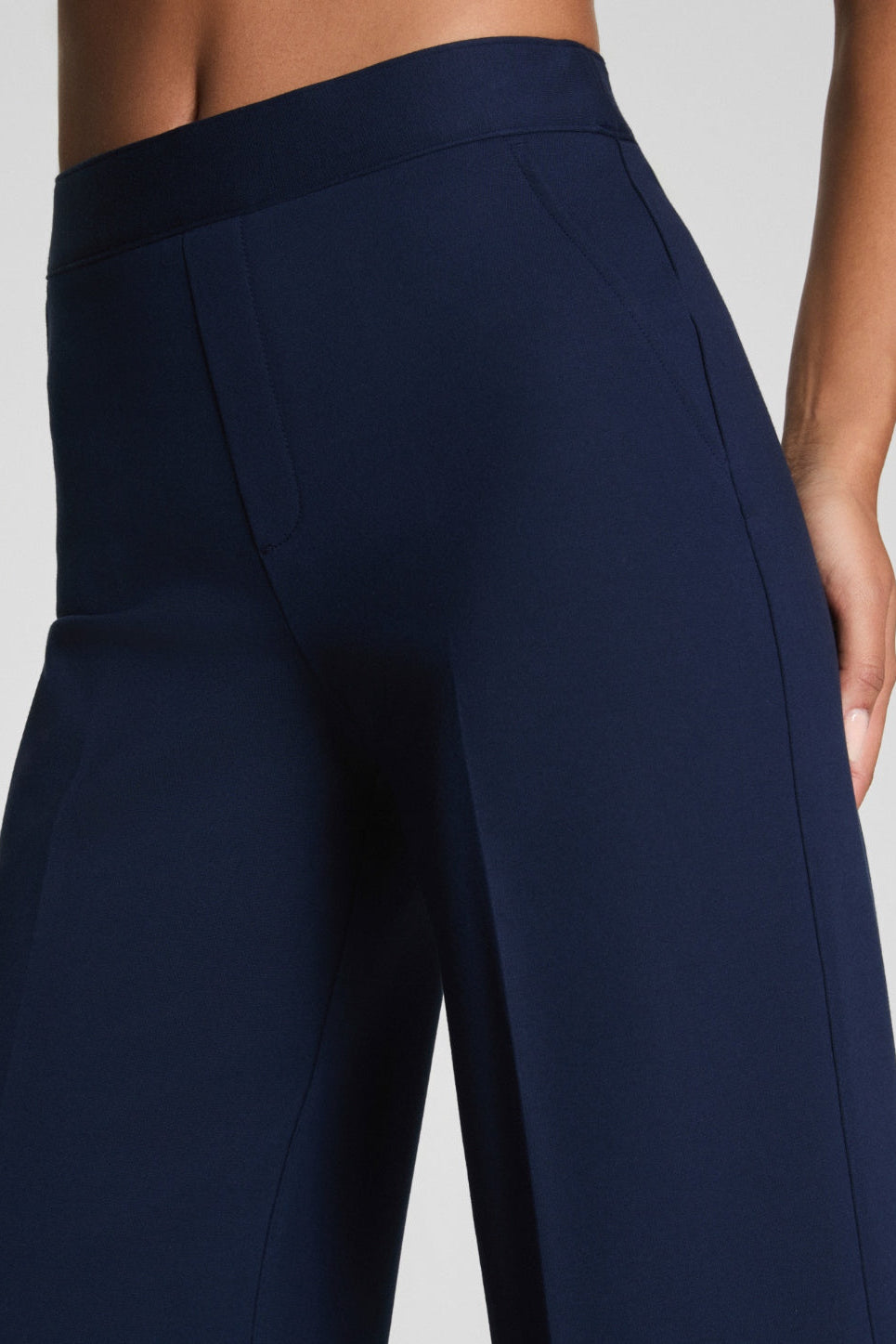 Navy blue pants on a plain background