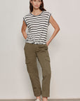 Woman wearing a striped shirt and cargo pants against a plain background