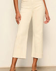 Person wearing white wide-leg pants against a plain background
