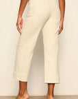 Person wearing beige pants against a plain background