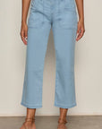 Light blue jeans worn by a person on a neutral background