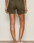 Person wearing olive green shorts on a plain background