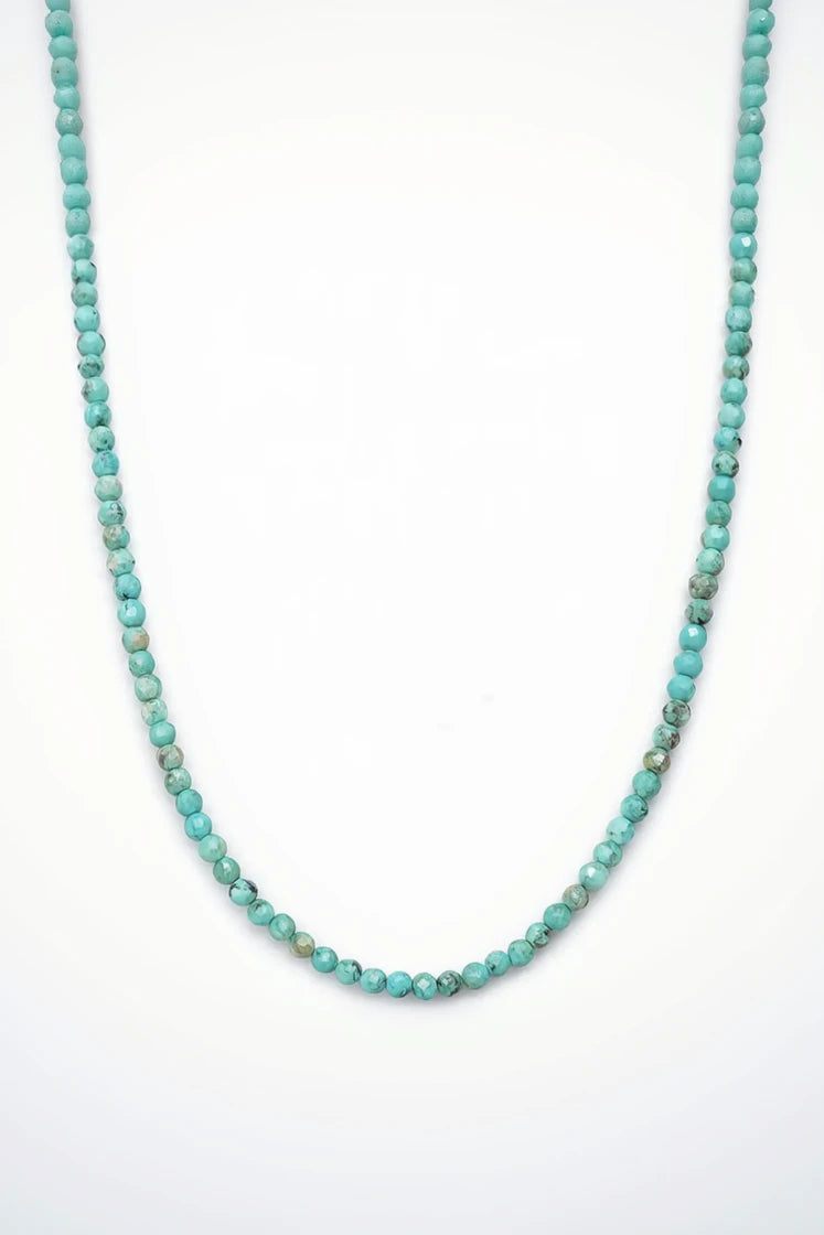 Turquoise beaded necklace on a white background