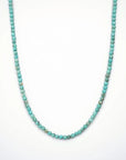 Turquoise beaded necklace on a white background