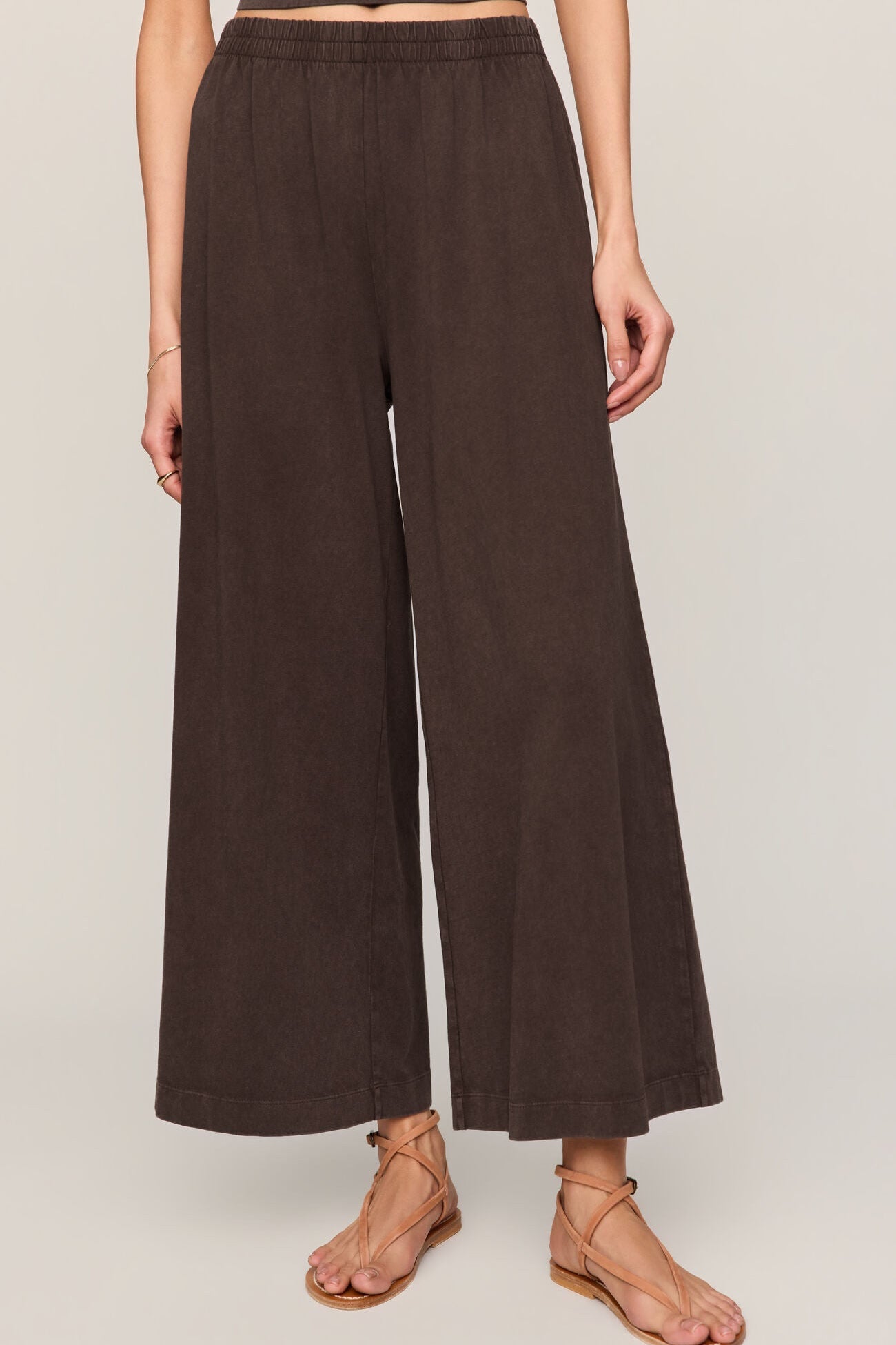 Brown wide-leg pants worn by a person on a plain background