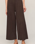 Brown wide-leg pants worn by a person on a plain background