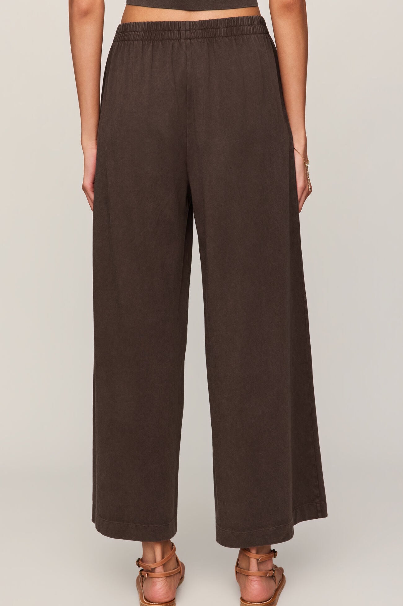 Brown wide-leg pants worn by a person on a plain background