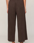 Brown wide-leg pants worn by a person on a plain background