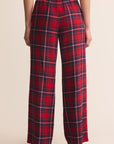 Red plaid pants worn by a person on a beige background