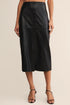 Black leather skirt worn by a person on a beige background