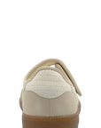 A single cream-colored slip-on shoe with a textured crocodile-patterned heel panel and a tan sole, shown from the back against a white background.