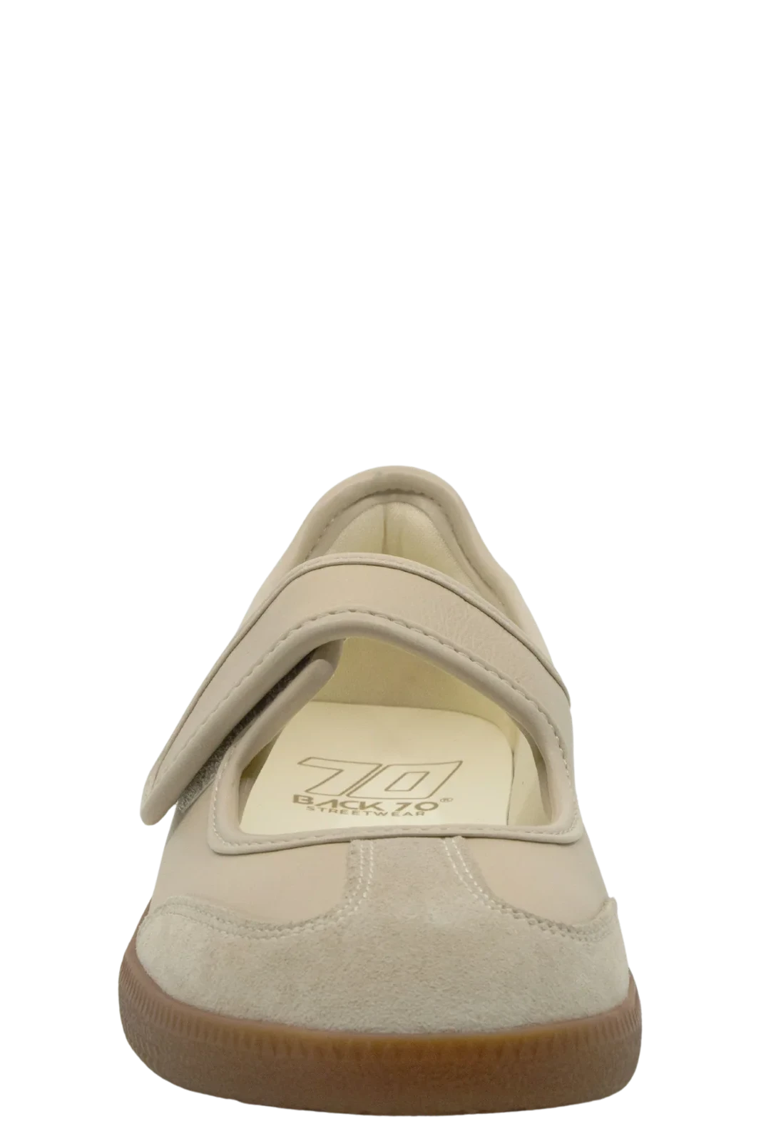 Beige shoe with a brown sole on a white background