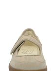 Beige shoe with a brown sole on a white background