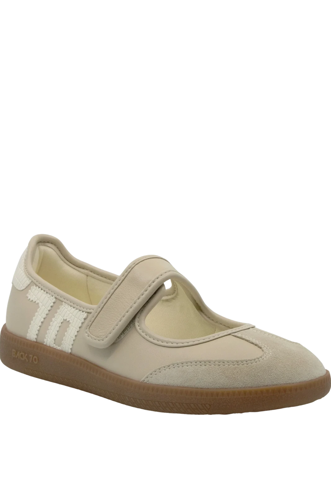 Beige shoe with a brown sole on a white background