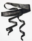 Black leather belt with a decorative buckle on a white background