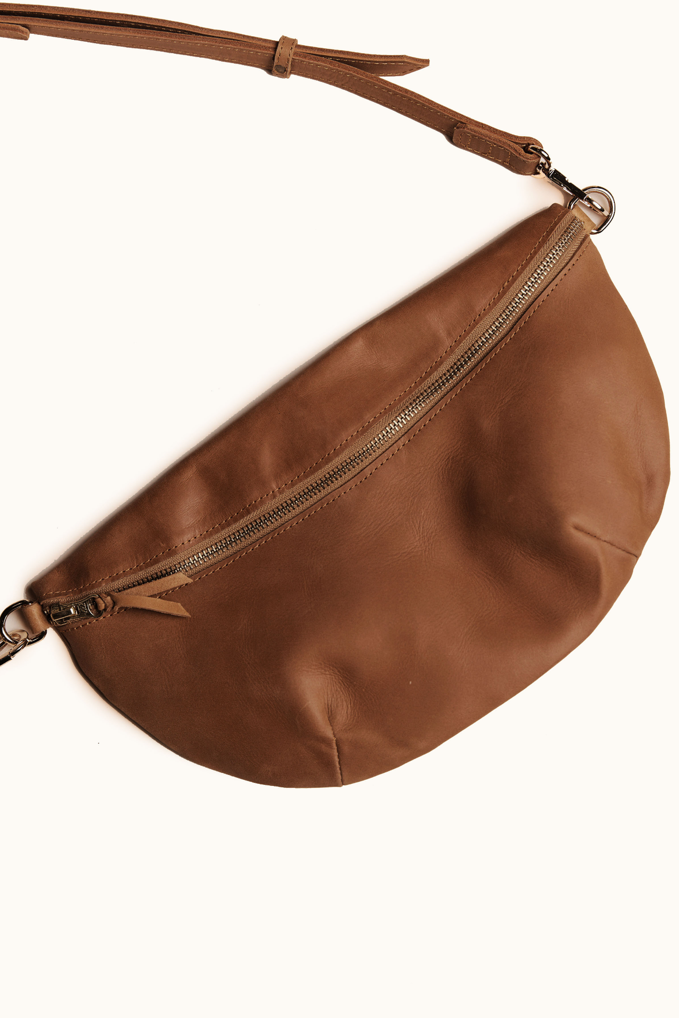 Brown leather waist bag on a white background