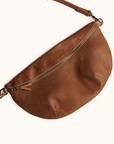 Brown leather waist bag on a white background
