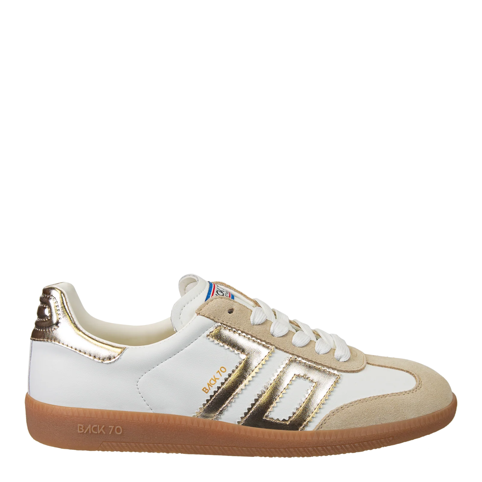 White and gold sneaker with brown sole on a white background