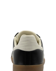Black and white sneaker with a brown sole on a white background