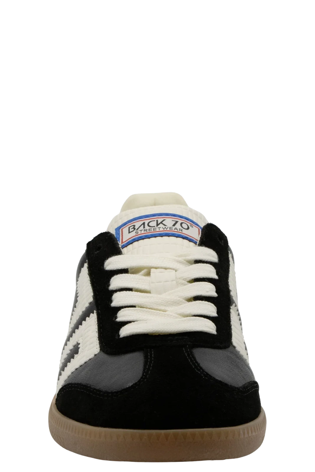A single Back 70 sneaker shown from the front on a solid white background. The shoe features a black suede upper, off-white leather panels and laces, a black leather toe cap, and a gum rubber sole.