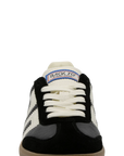 A single Back 70 sneaker shown from the front on a solid white background. The shoe features a black suede upper, off-white leather panels and laces, a black leather toe cap, and a gum rubber sole.