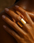Gold ring on a hand with a sunlit background