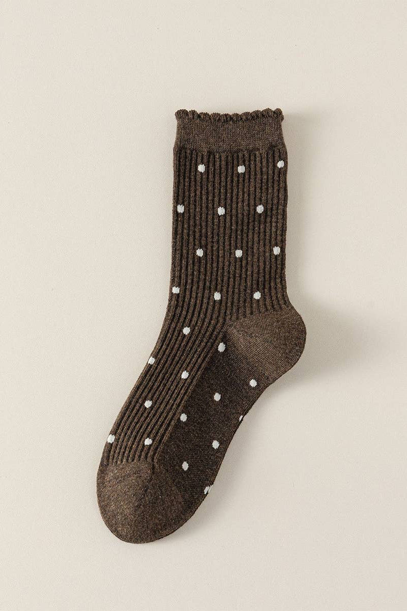Brown sock with white polka dots on a beige background
