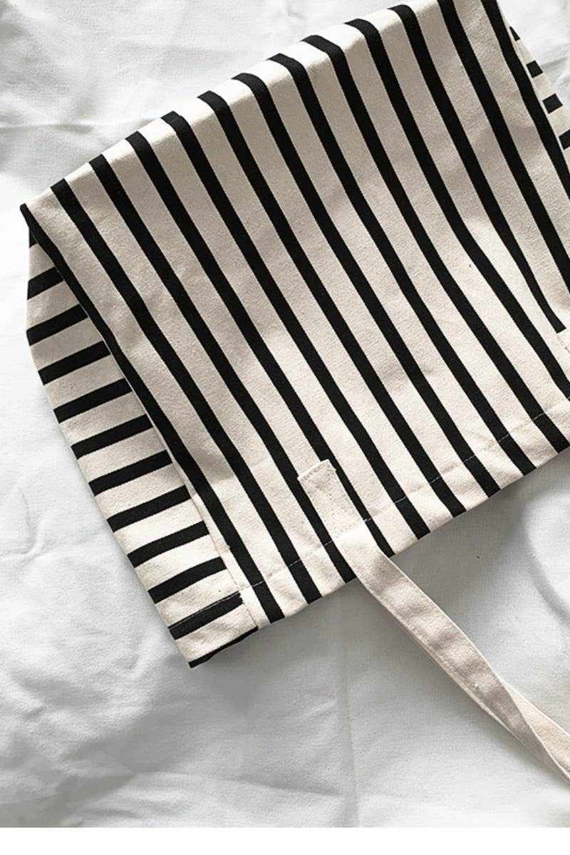 Black and white striped tote bag on a white background