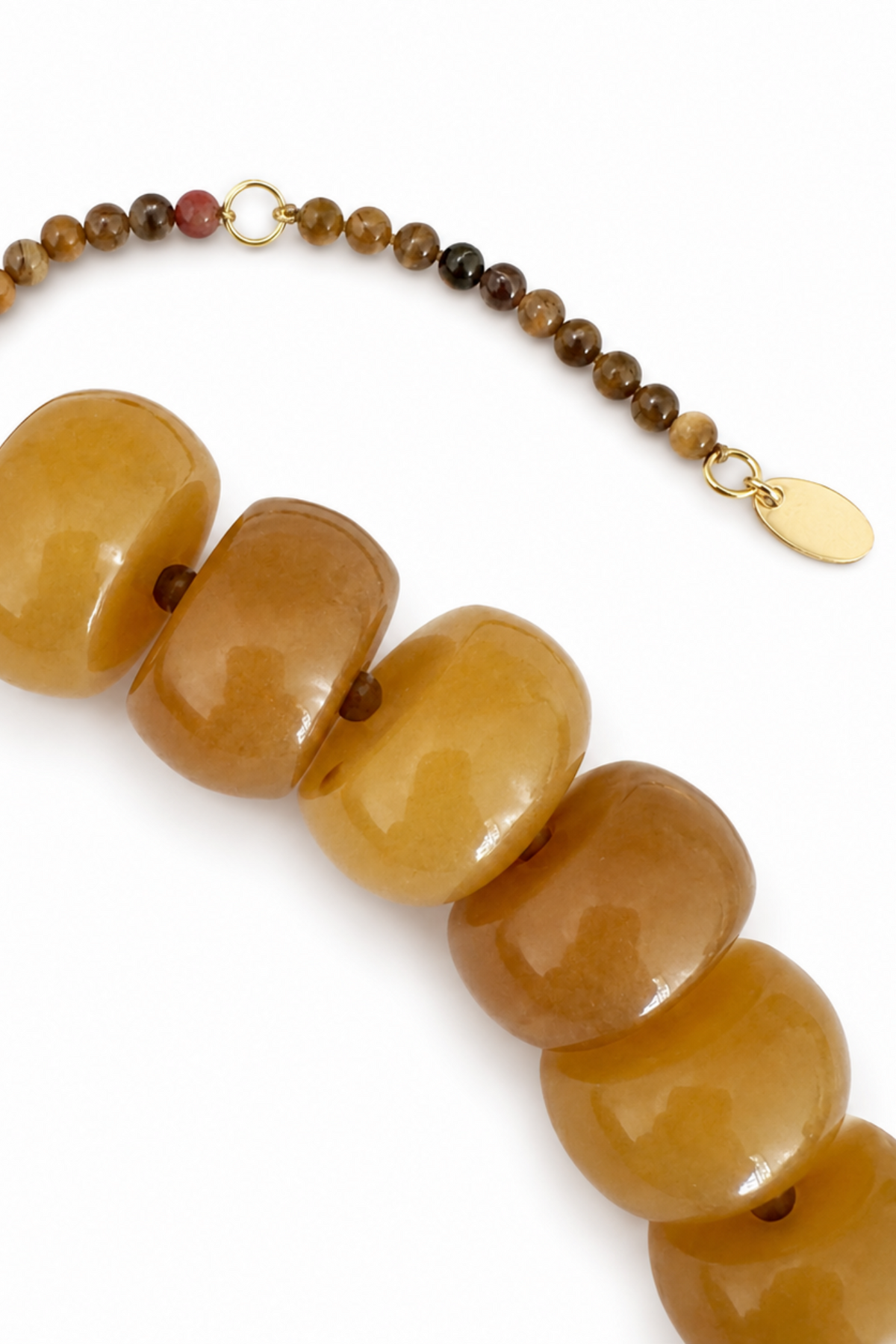 Bracelet with brown beads and gold clasp on a white background